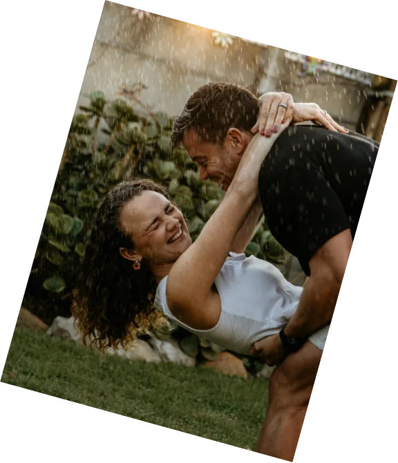 Anru dipping Leane on the grass, both laughing