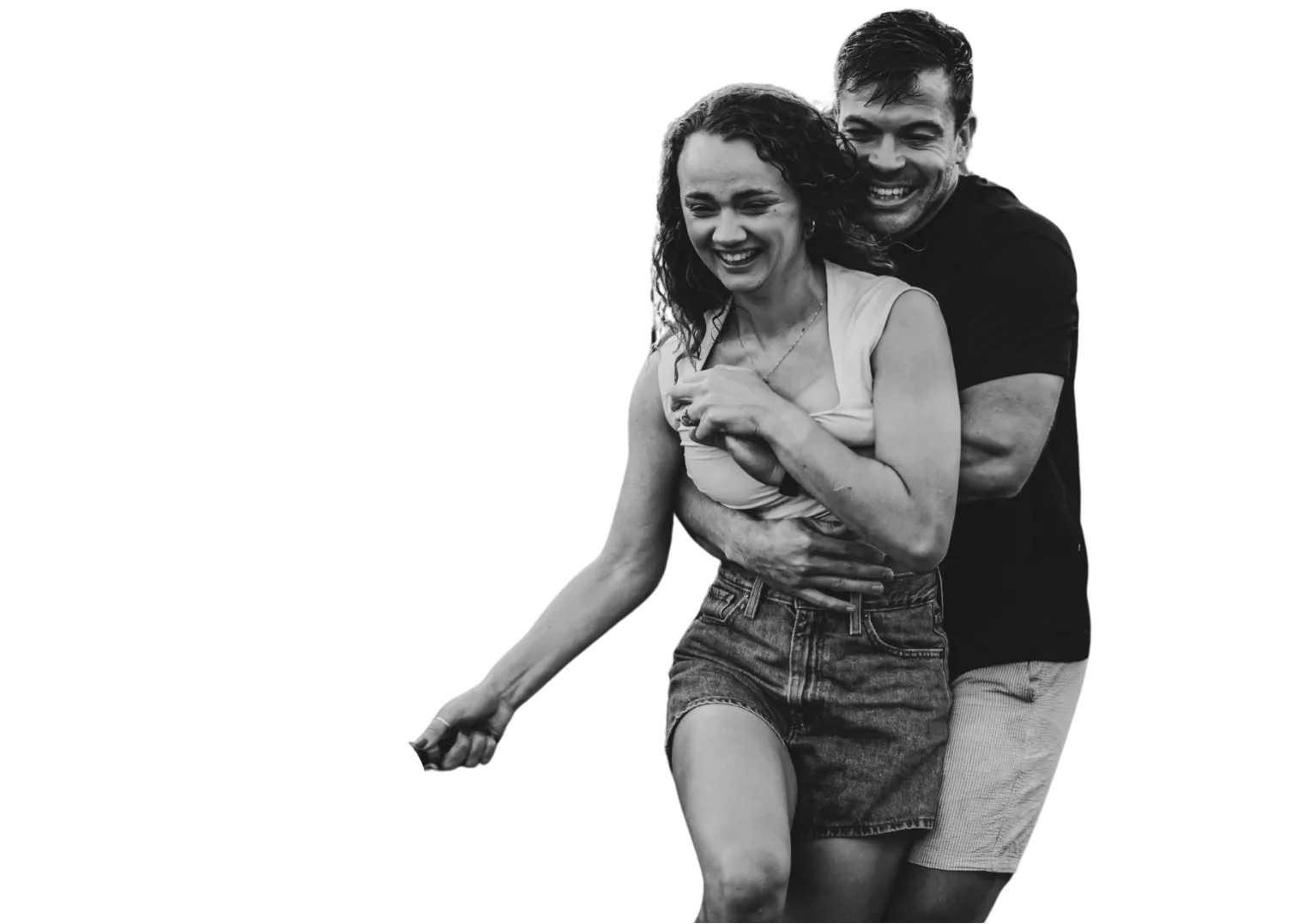 Black and white photo of Anru hugging Leane from behind, both laughing